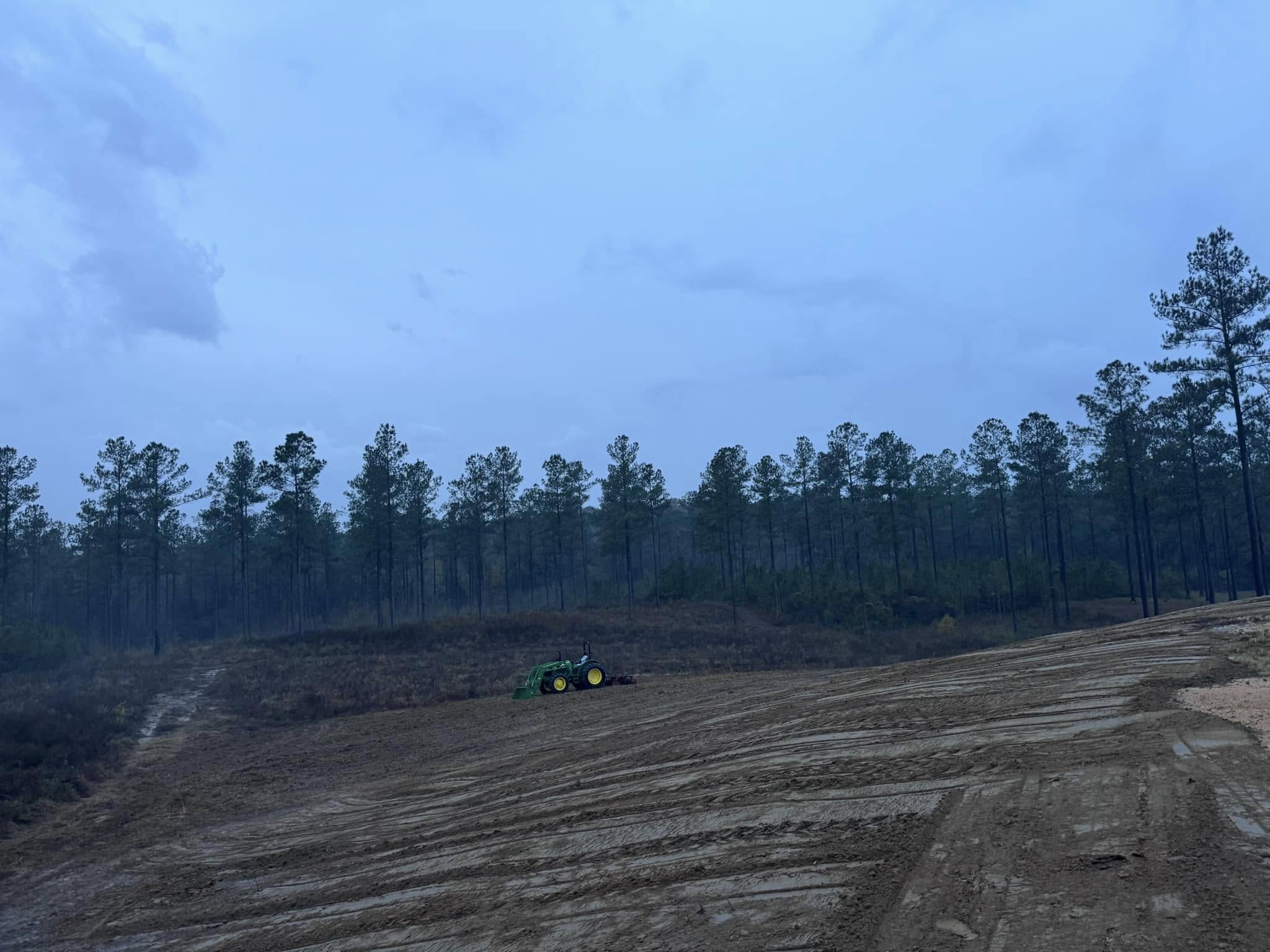 John Deere tractor working on large land clearing project