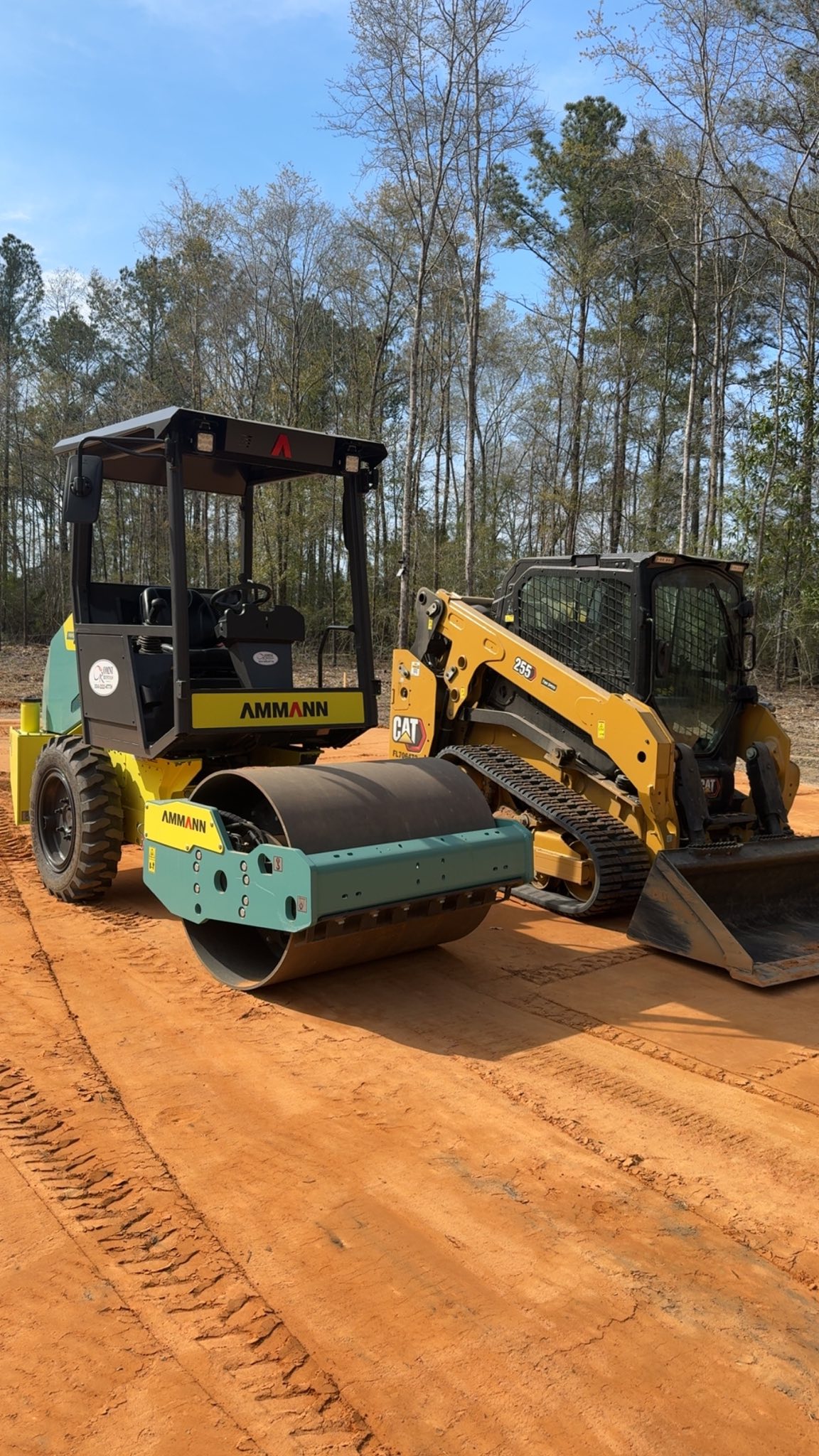 Ammann roller and CAT skid steer for road construction