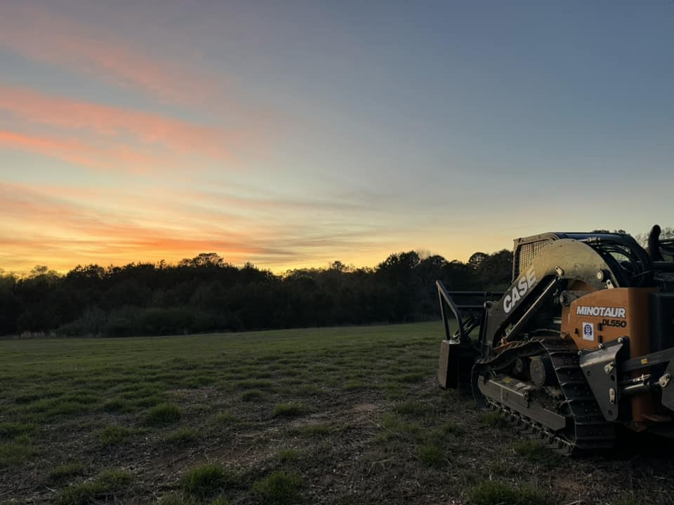 Case Minotaur equipment at sunset in cleared field
